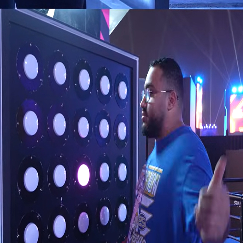 Player faces light grid in challenge game arena