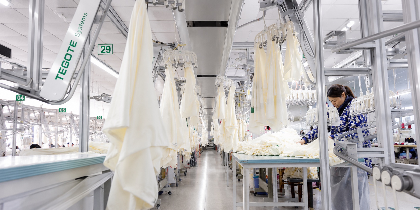 Automatic TEGOTE hanging garment production assembly line inside our modern sewing workshop