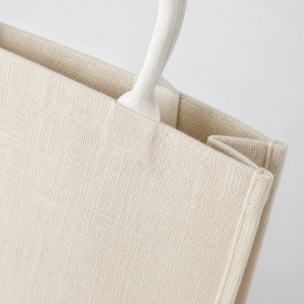 Close-up of a coarse woven shopping bag surface and handle