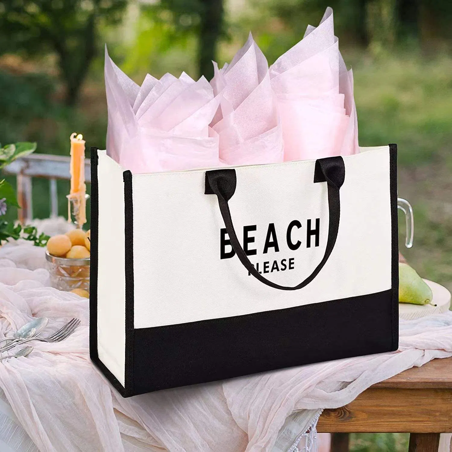 Reusable black and white shopping tote shown in a real outdoor setting