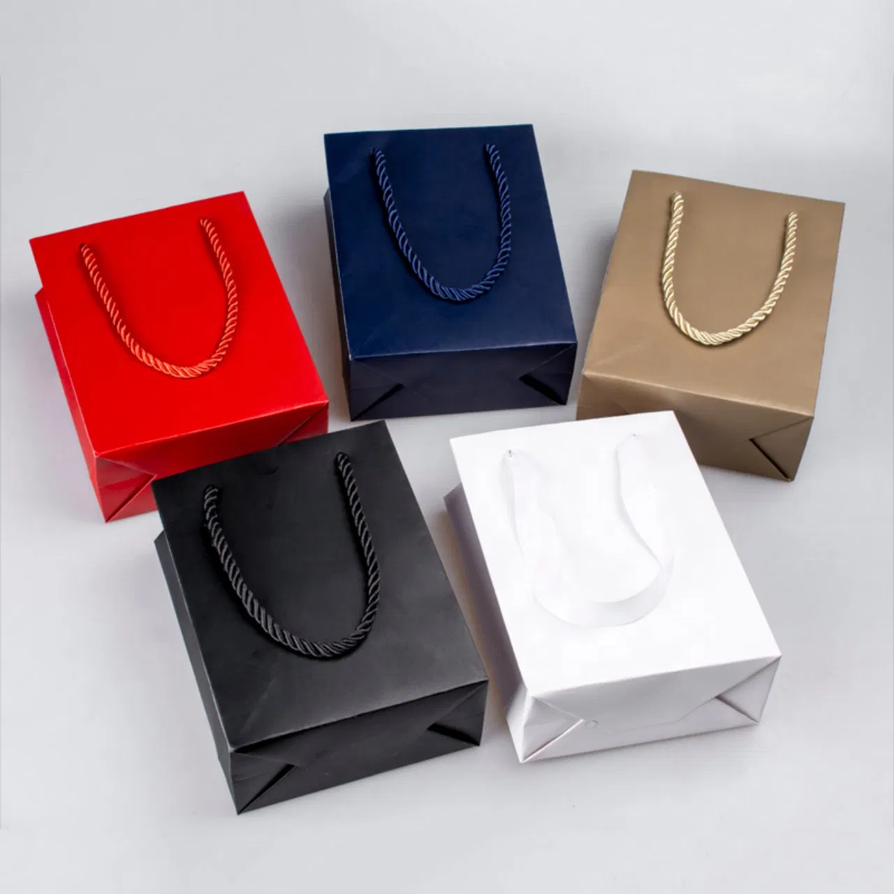 Metallic paper shopping bags with rope and ribbon handles