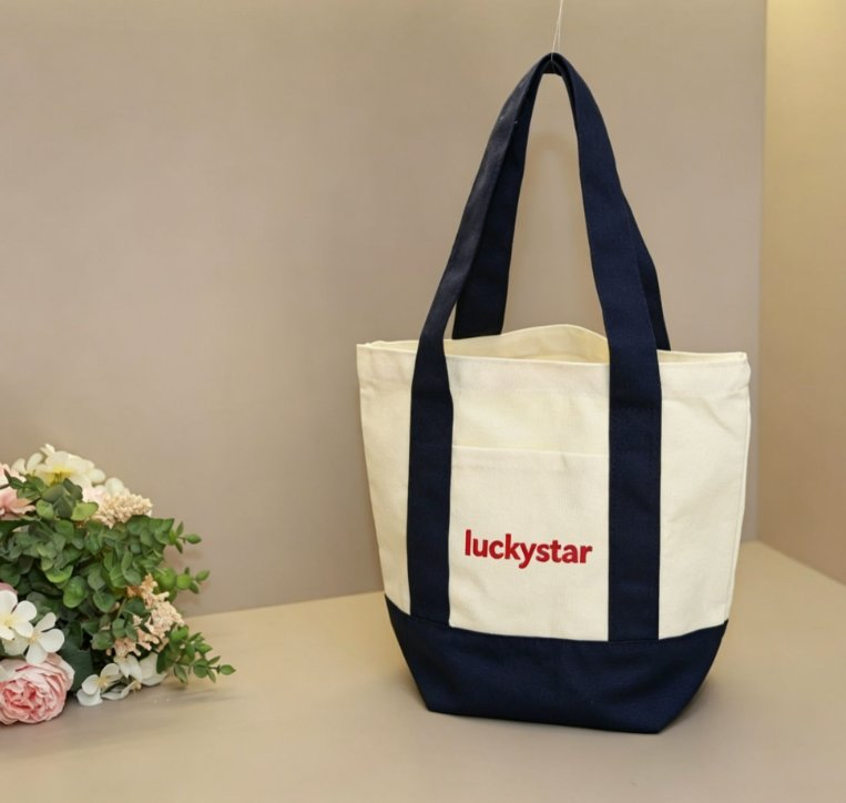 LUCKYSTAR tote with continuous contrast handles and visible attachment path
