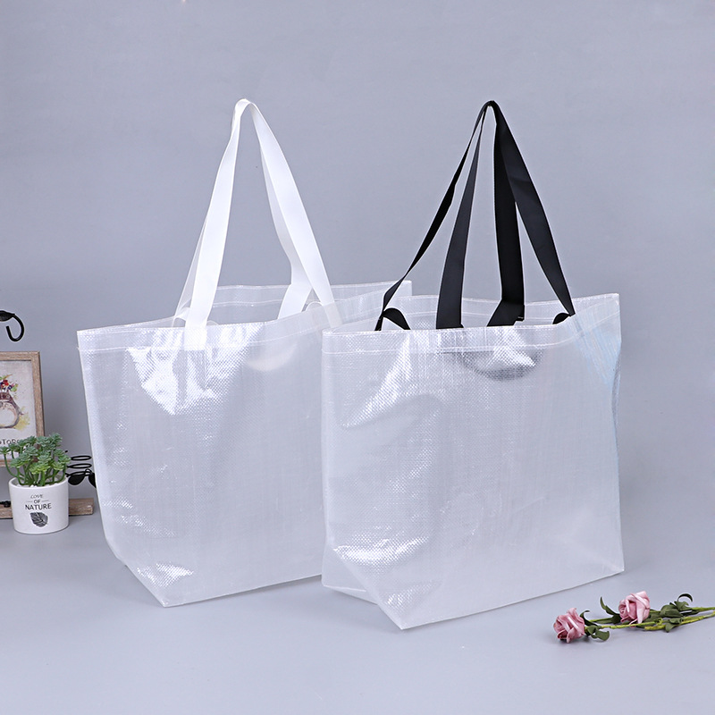 Two transparent woven polypropylene shopping bags with white and black handles