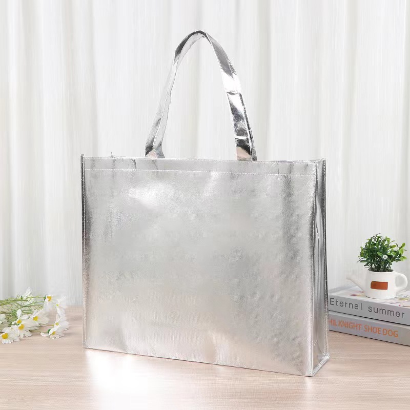 Silver laminated non-woven polypropylene shopping bag on a tabletop