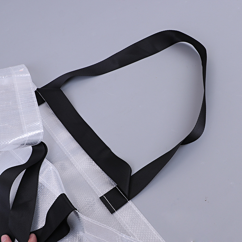 Close-up of black webbing handles attached to woven polypropylene bag panels