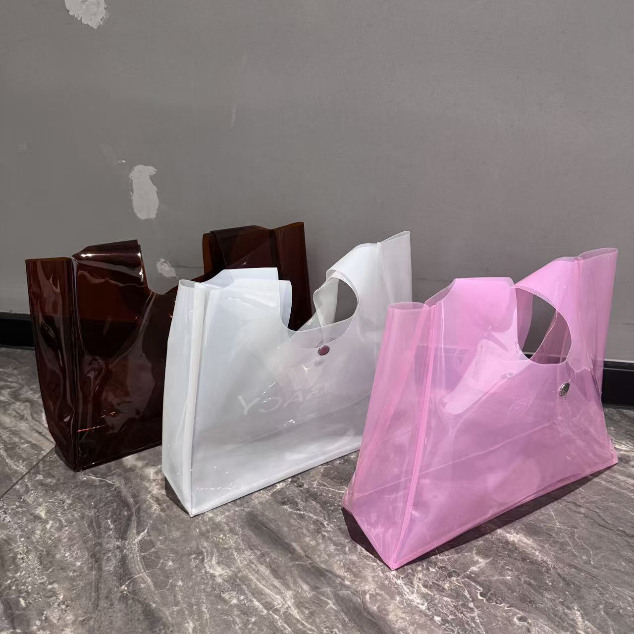 Different transparent shopping bag formats photographed as physical samples