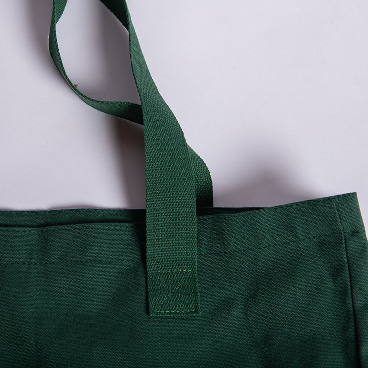 Close-up of shopping bag handle attachment and top hem stitching