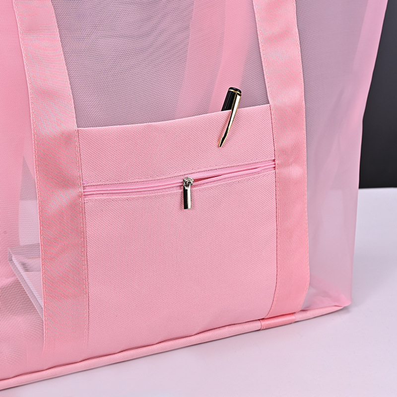 Close-up of a mesh shopping bag pocket, binding and strap junction