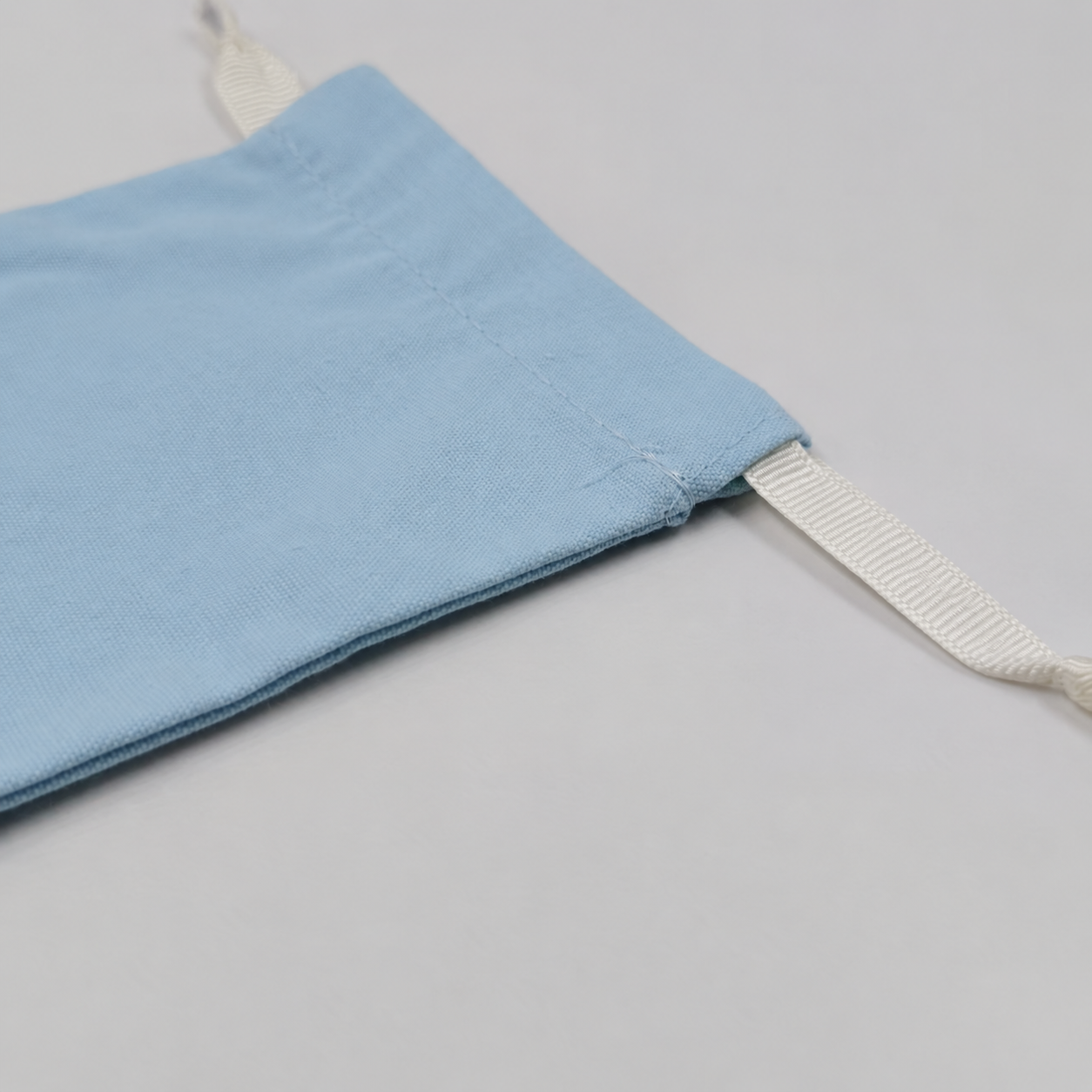 Drawstring bag cord and seam detail